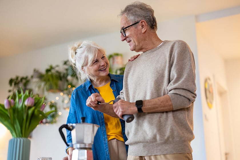 Senior couple preparing coffee at home