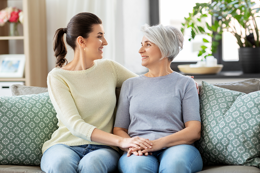 senior-mother-with-adult-daughter-hugging-at-home